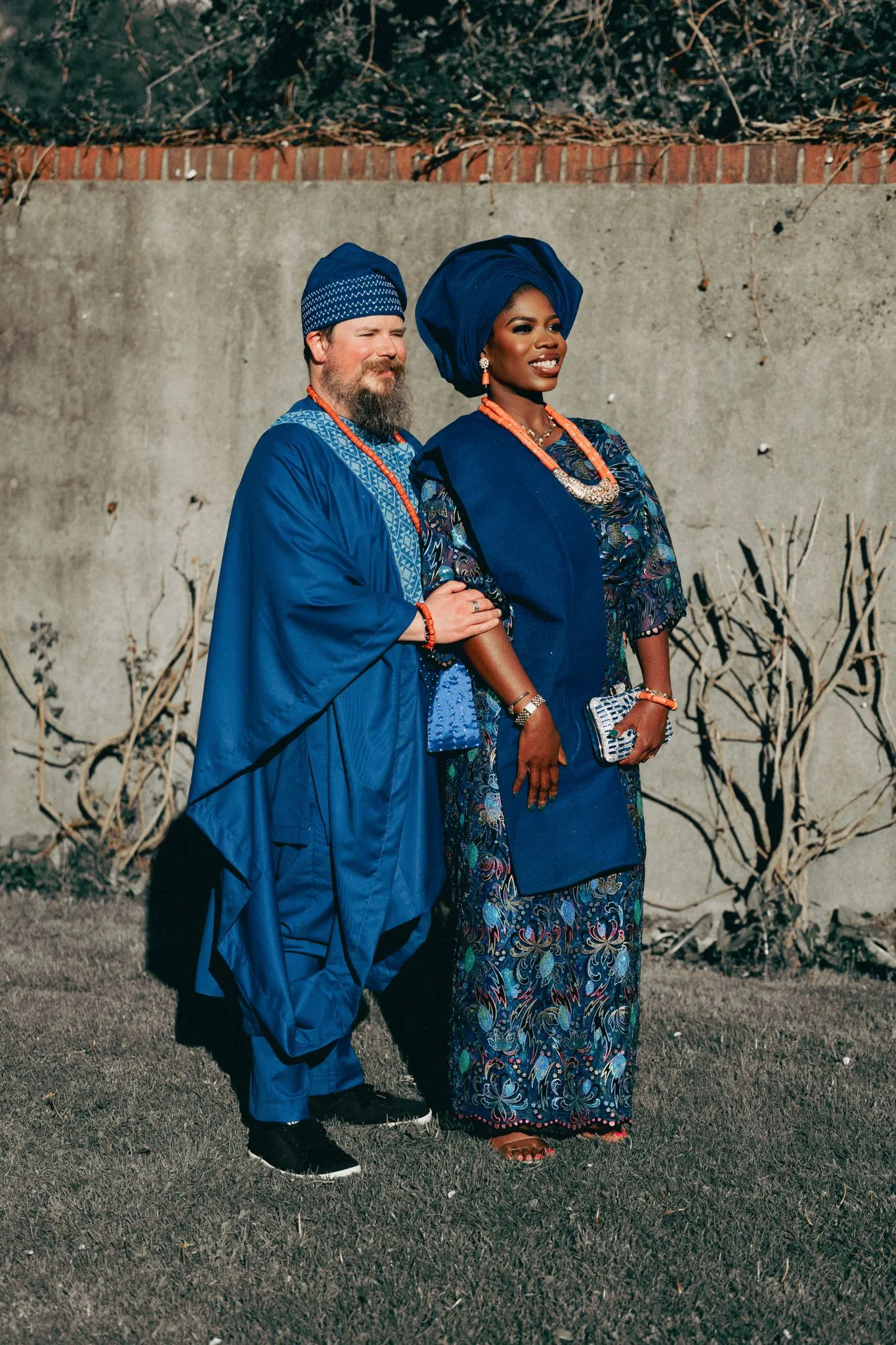 Couple in traditional blue attire standing outdoors