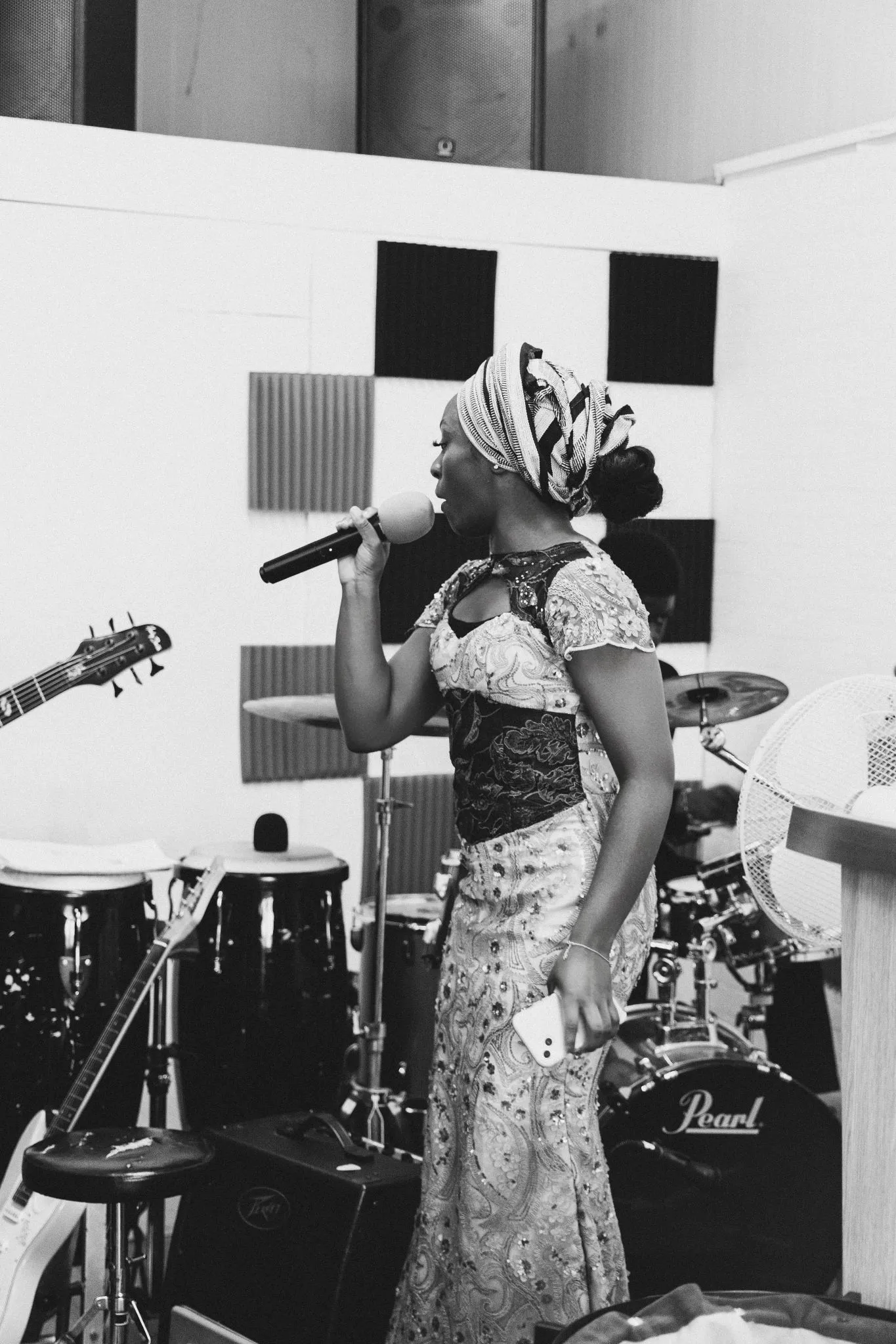 African musician performing with microphone and traditional attire