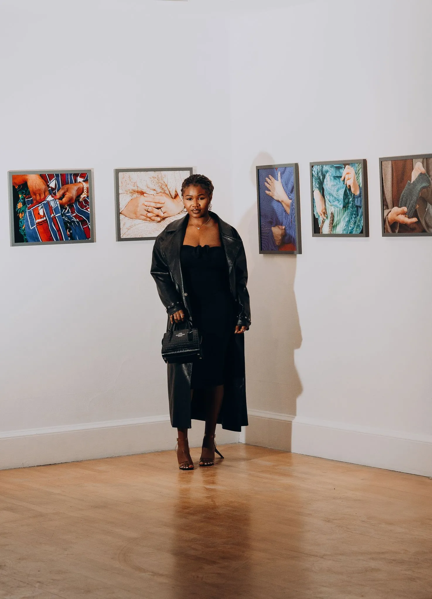 Art gallery visitor viewing colorful paintings on display.