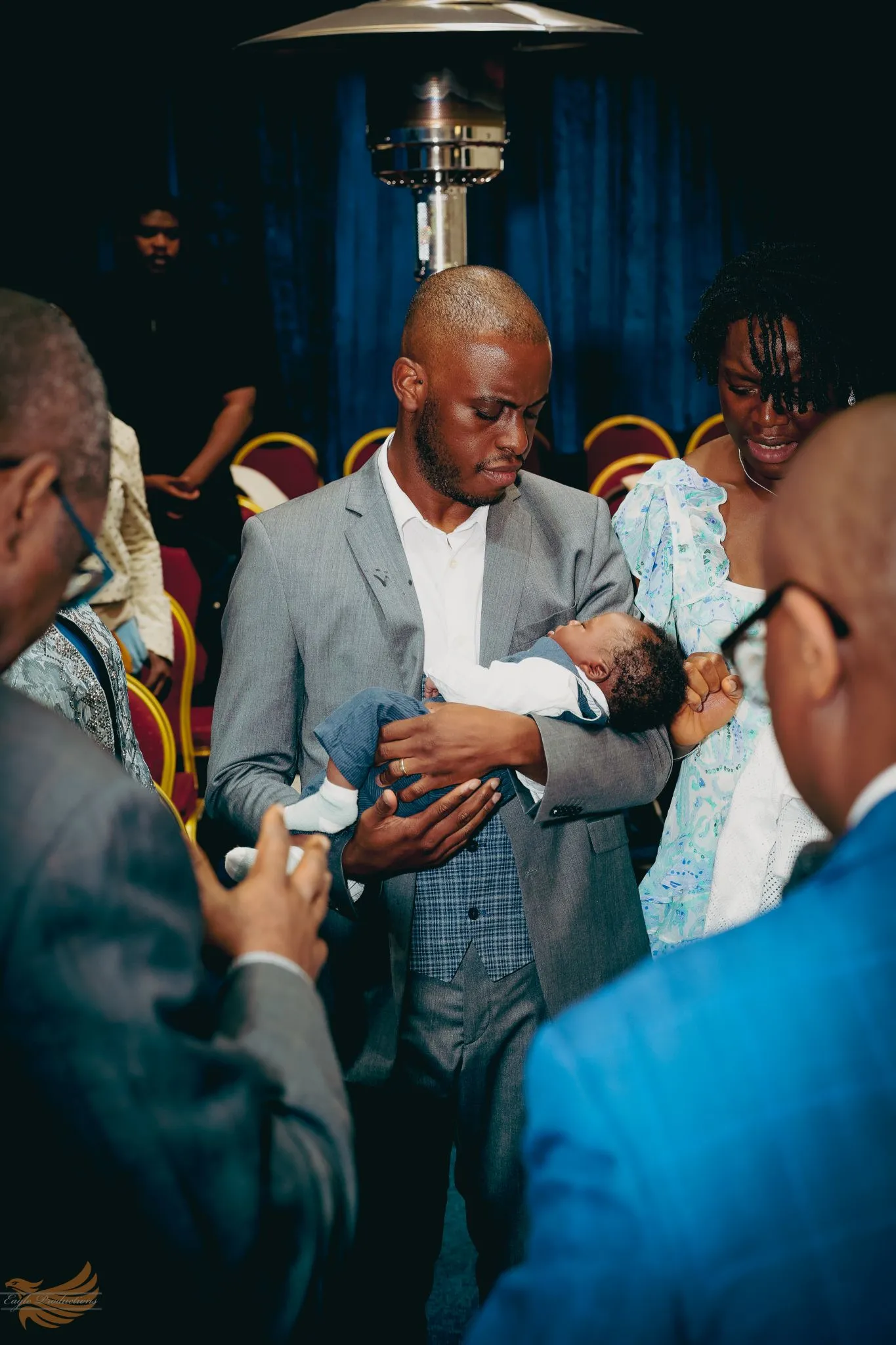 Family at baby christening ceremony in church setting