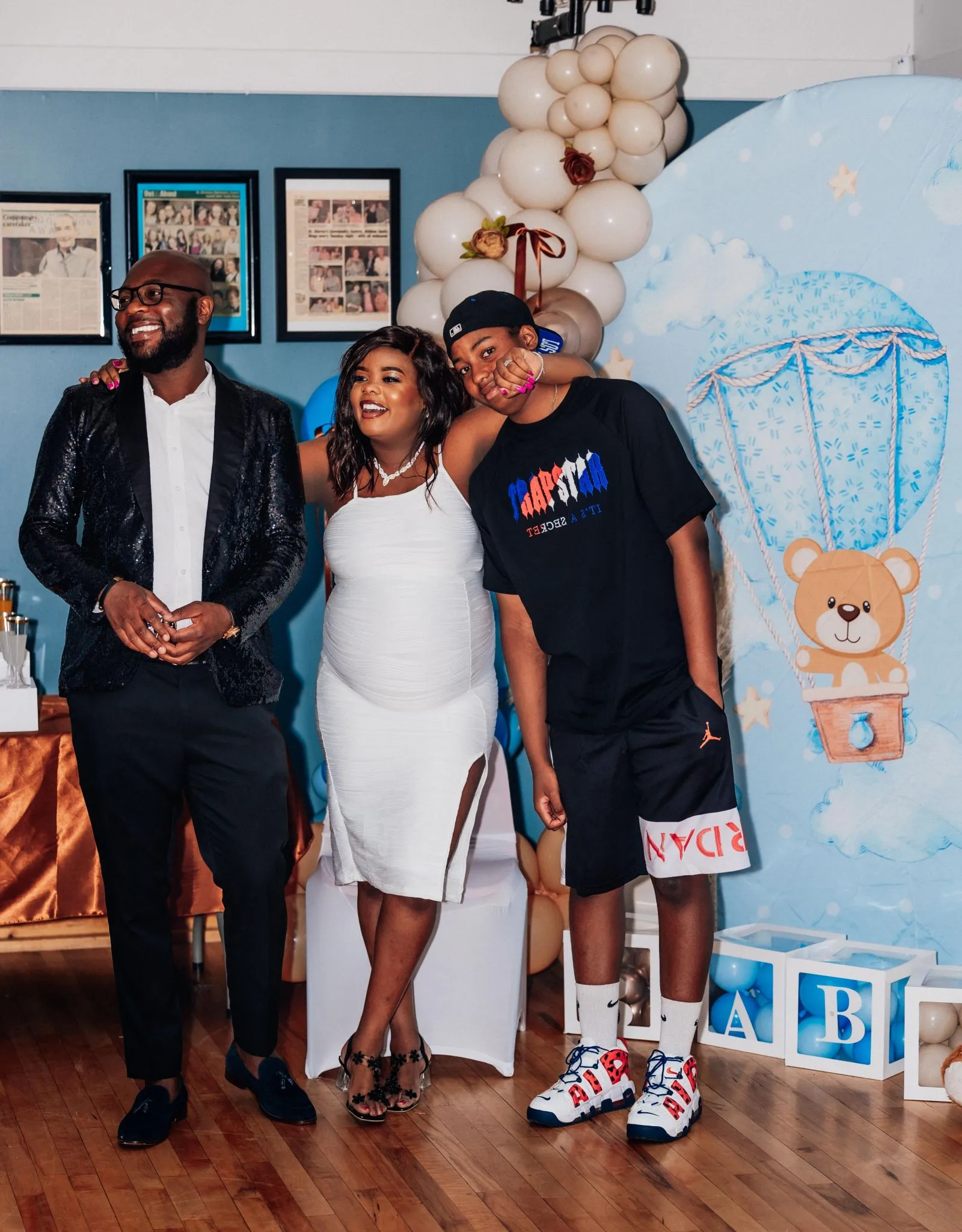 Joyful baby shower celebration with guests and balloon decorations.