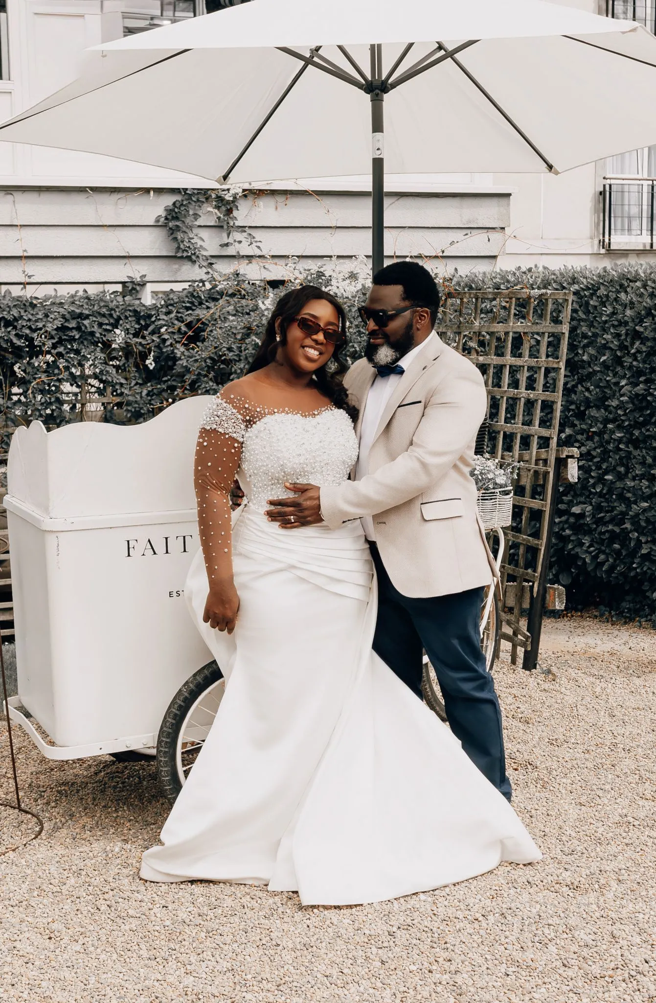 Bride and groom smiling outdoors in elegant attire