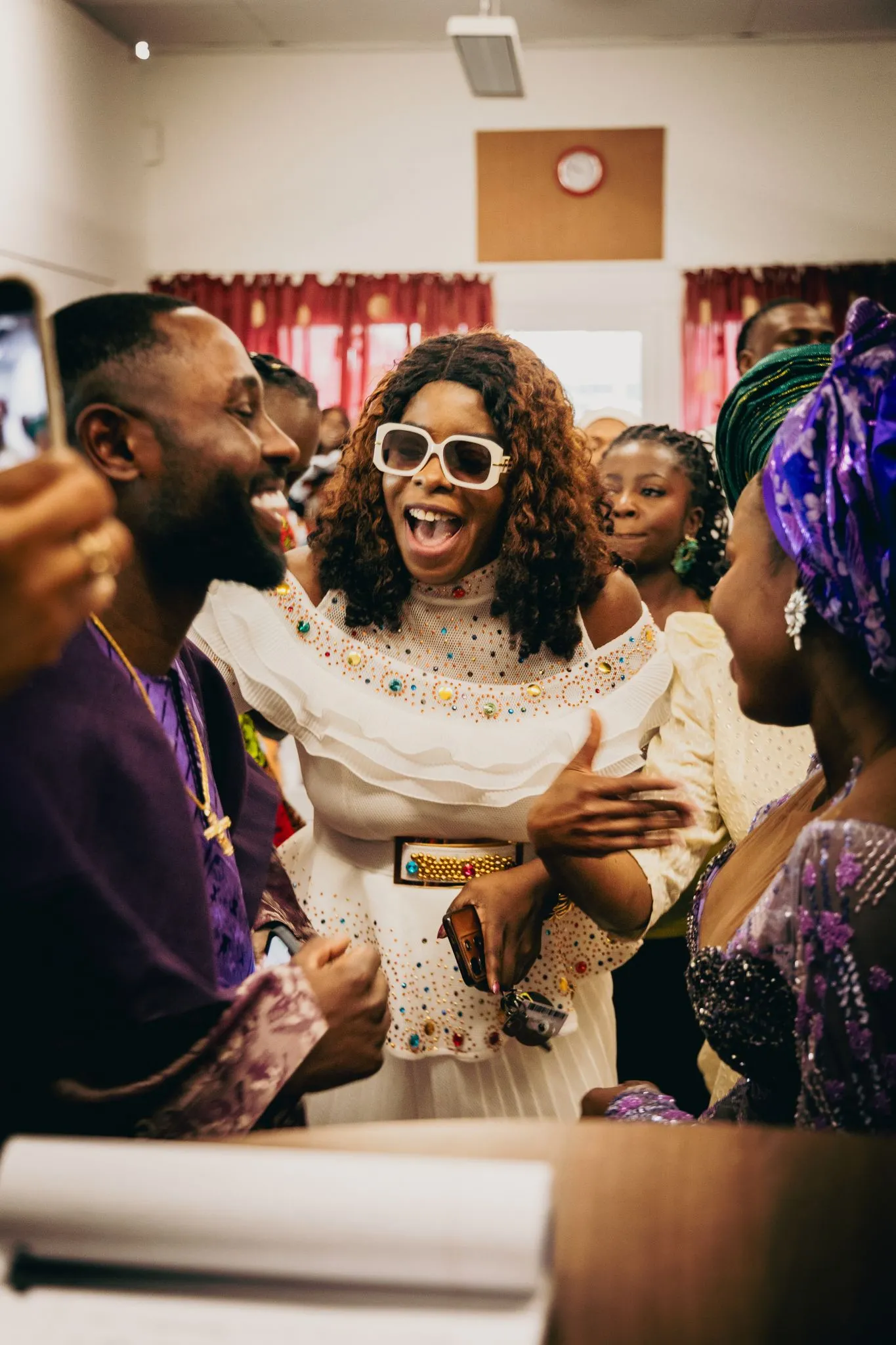 Joyful gathering with people celebrating and smiling together.