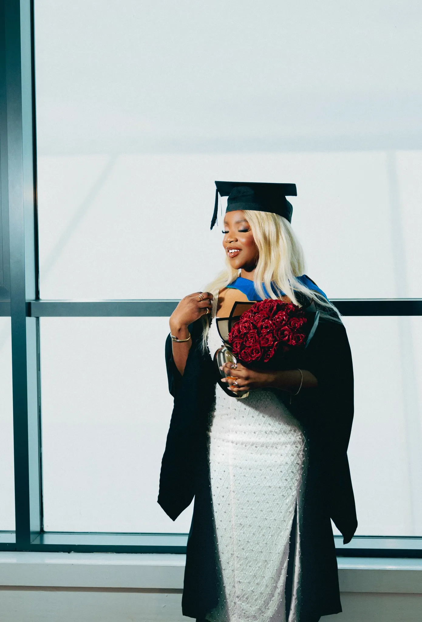 Eagle Productions Graduation Woman Gown Roses Glass Building