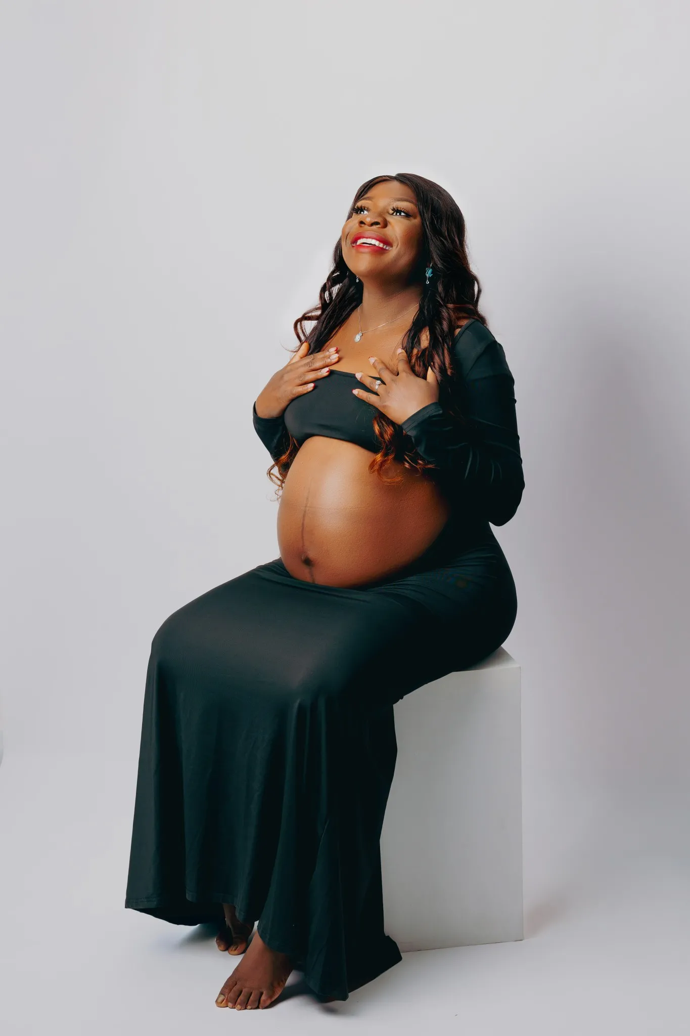 Eagle Productions Maternity Woman Black Gown Seated