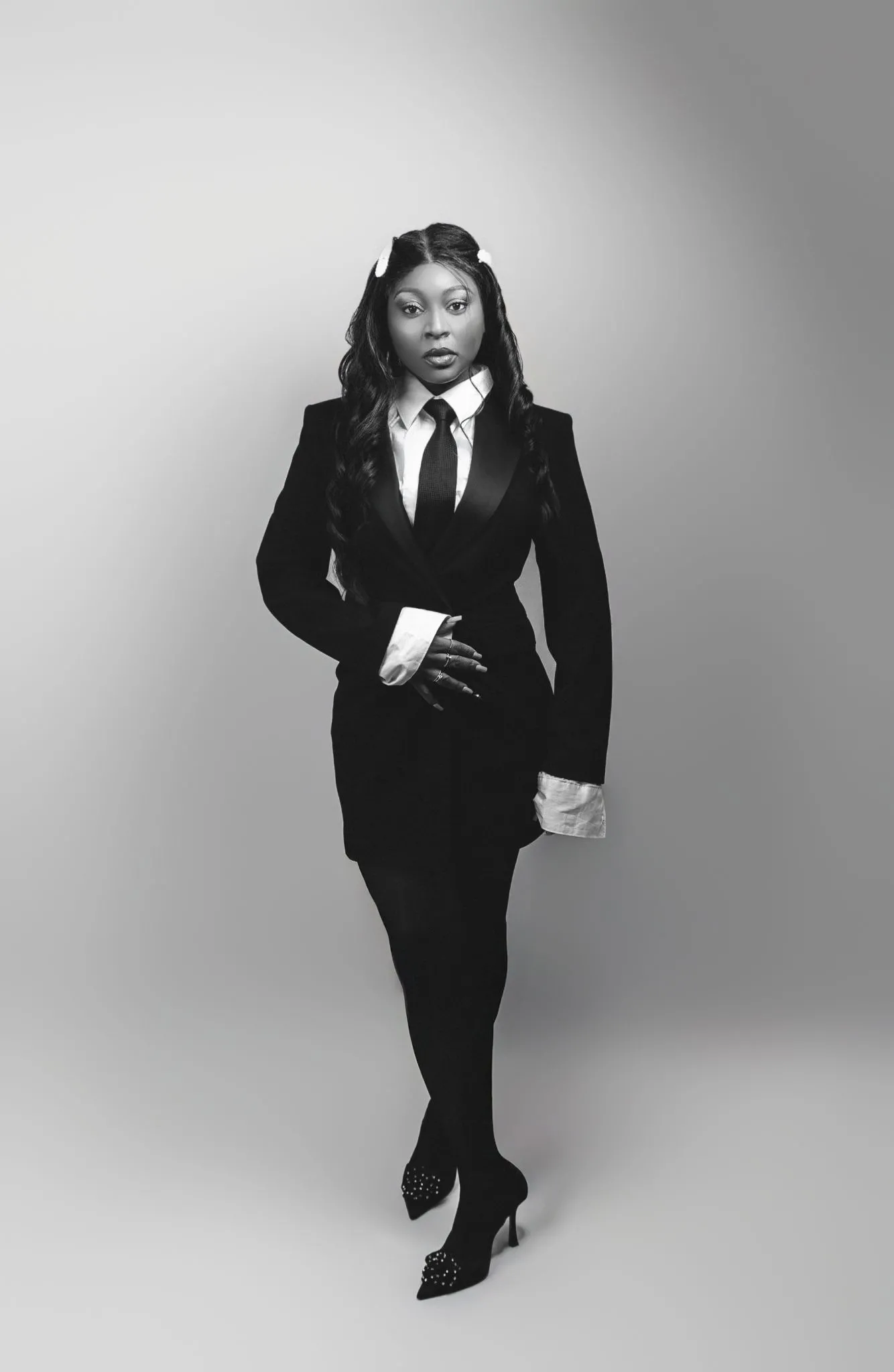 Person in elegant business attire with a confident pose.