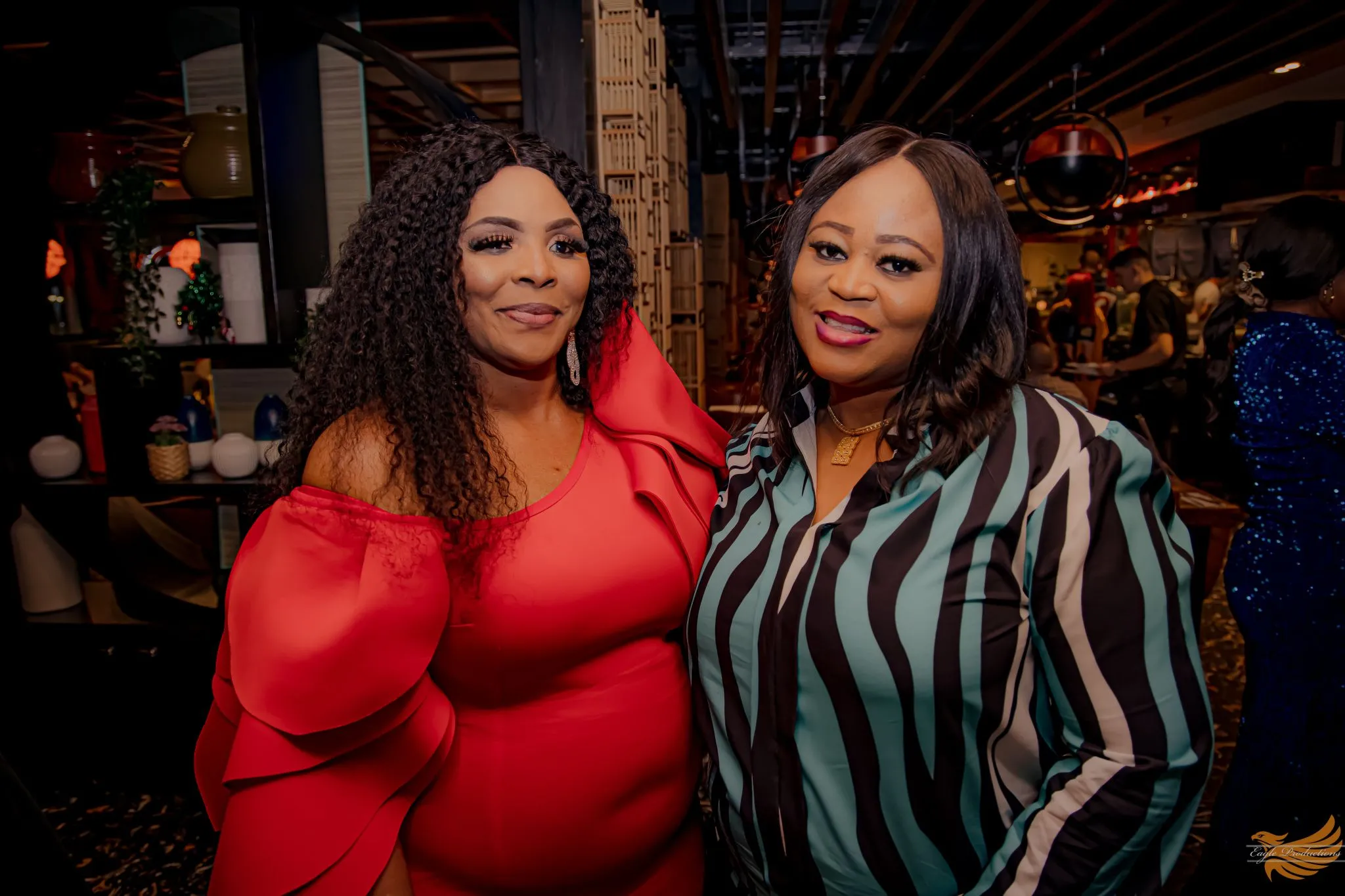 Two guests smiling at an event celebration hosted by Eagle.