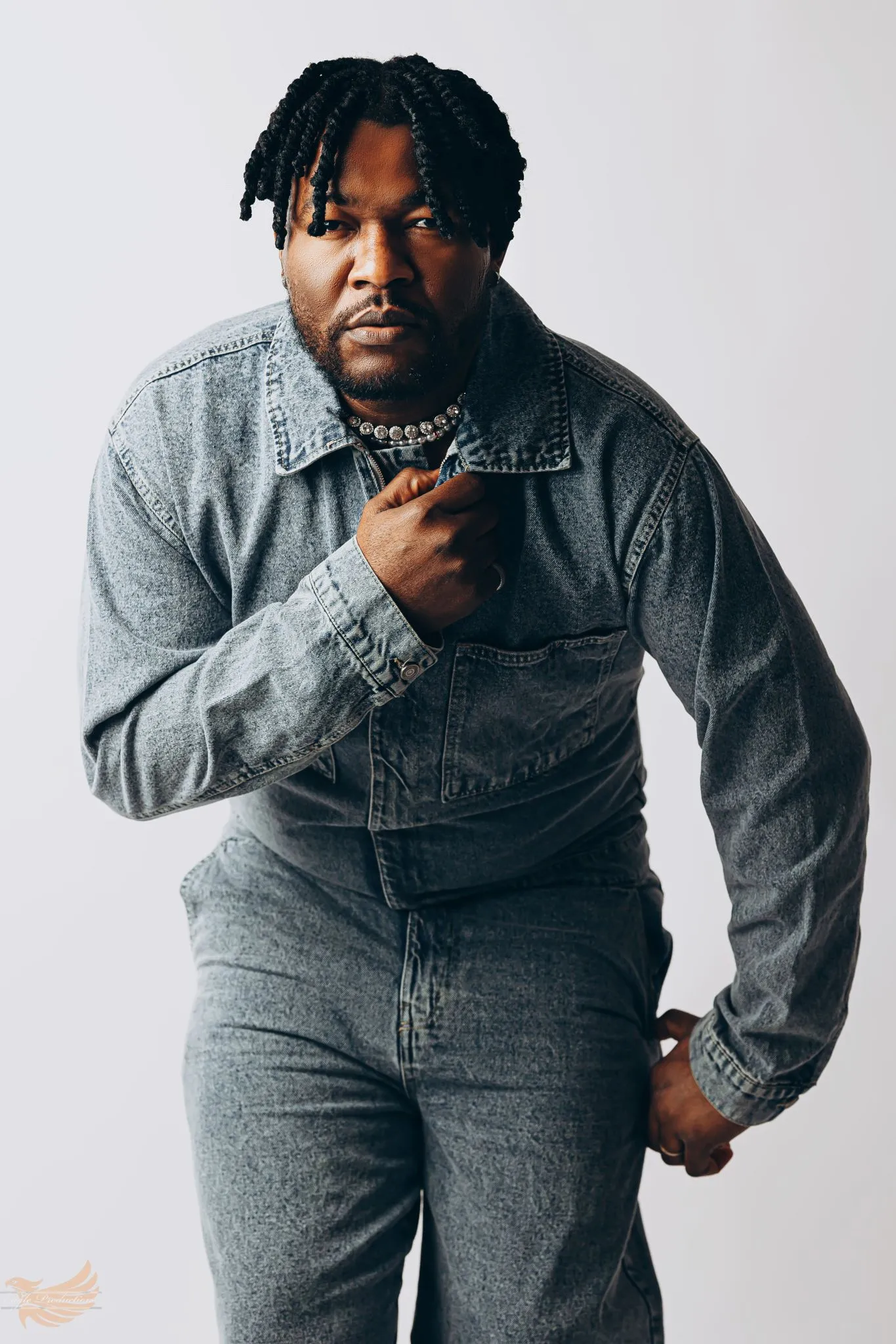 Man in denim outfit posing confidently