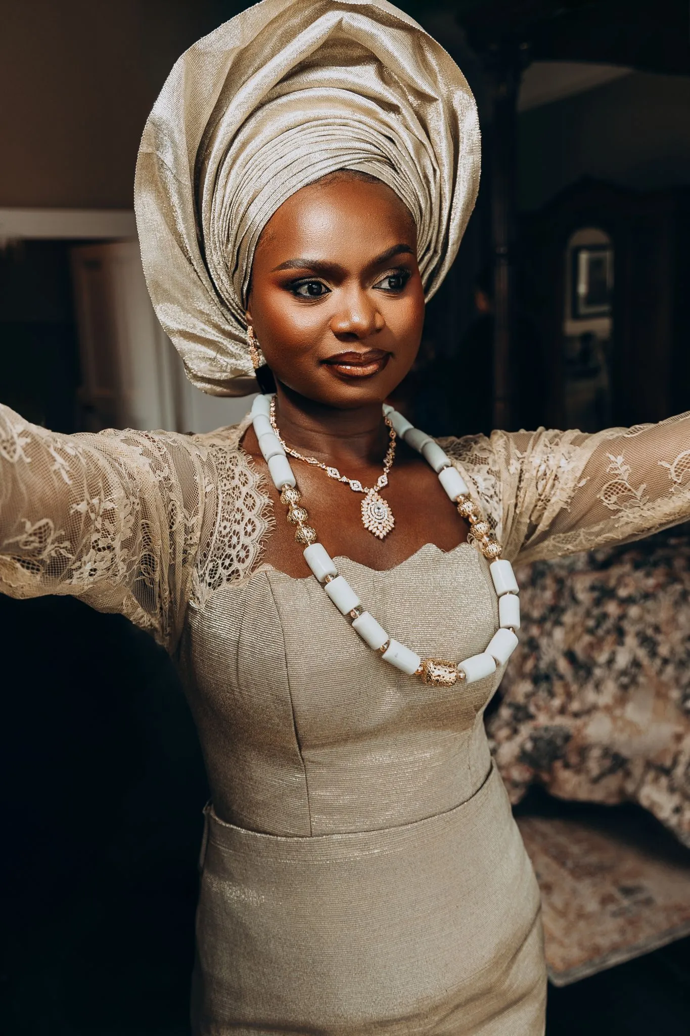 Nigerian bride in traditional attire with gele and jewelry