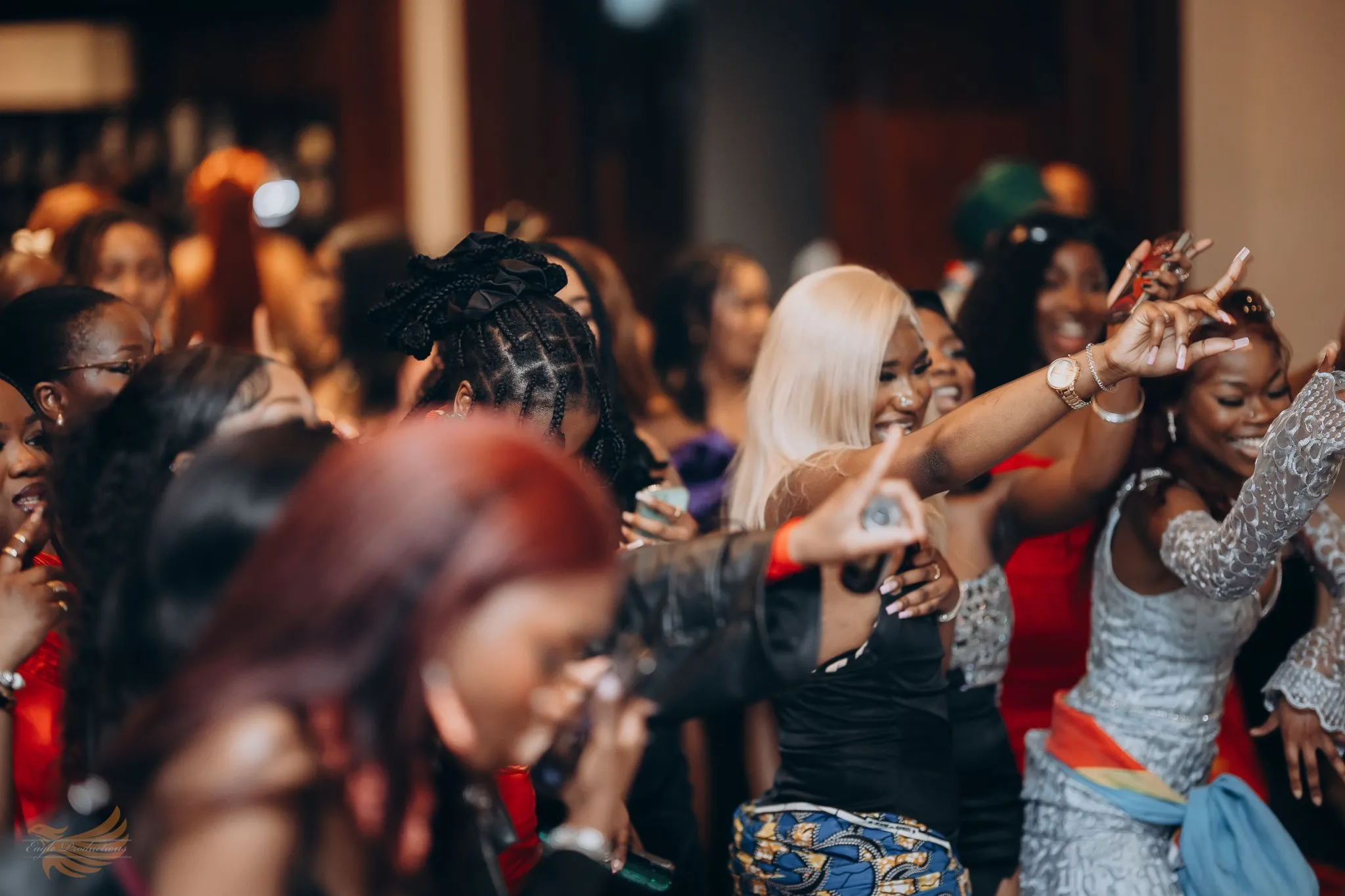 Group of people dancing and celebrating at a lively party