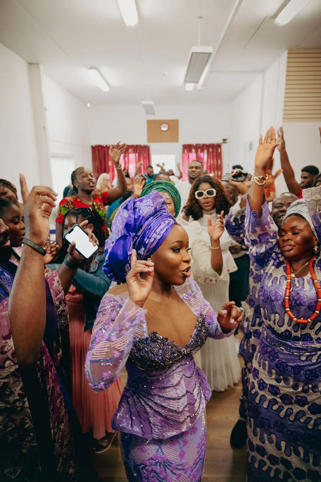 Vibrant cultural celebration with people in colorful attire dancing joyfully.